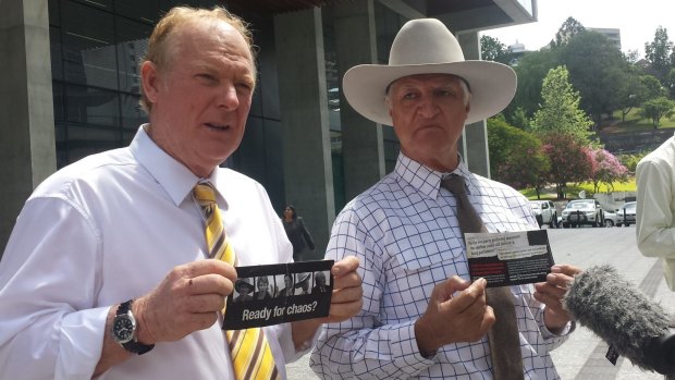KAP state leader Shane Paulger and leader Bob Katter display LNP pamphlets outside Brisbane's Supreme Court.