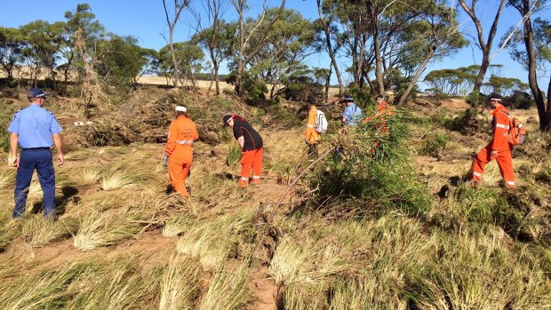 SES volunteers and police searching for the missing man, now confirmed dead, on Monday. 