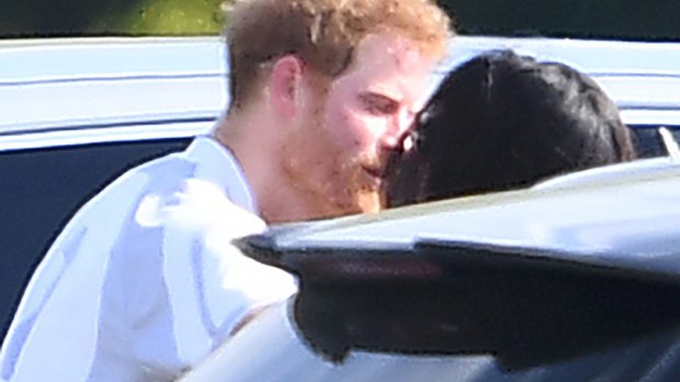 Meghan Markle and Prince Harry kiss and hug after Harry played in the Audi Polo Challenge earlier this month.