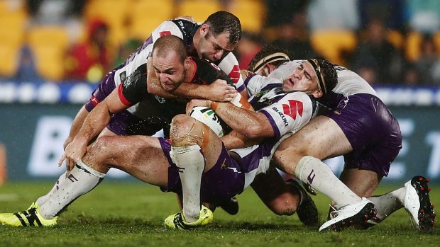 Tangle of bodies: Simon Mannering is tackled by Smith and Dale Finucane.