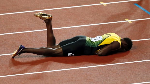 Dramatic finale: Usain Bolt lies on the track after pulling up injured in the final leg of the 4x100m relay at the World Athletics Championships.