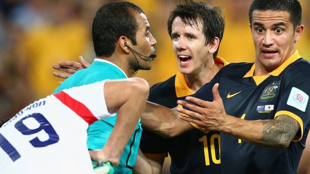 Tim Cahill argues with the referee.