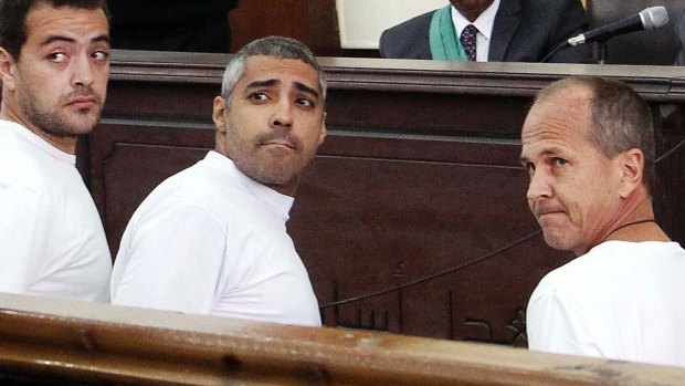 Al-Jazeera English producer Baher Mohamed, left, Canadian-Egyptian acting Cairo bureau chief Mohamed Fahmy, centre, and correspondent Peter Greste, right, in court in Cairo during the trial.
