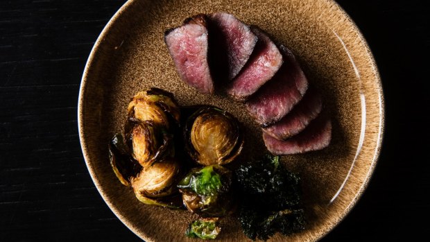 Wagyu sirloin with brussels sprouts and kale crisps.
