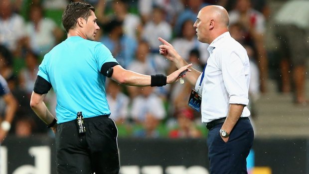 Easy does it: Referee Ben Williams asks  Victory coach Kevin Muscat to stay calm.