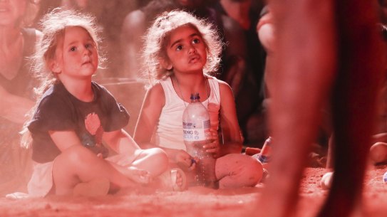 Children watch bands perform during the community event to celebrate the closure of the Uluru climb.