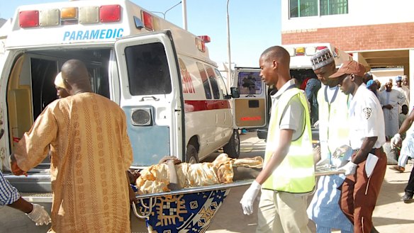 Rescue workers transport a victim of a suicide bomb attack  for treatment at a hospital in Maiduguri, Nigeria, on Wednesday.