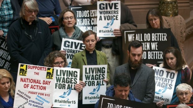 People rally on the Great Western Staircase at the New York Capitol in Albany on Tuesday. 