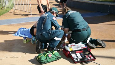 Paramedics treat a woman after allegedly being hit by a drone.