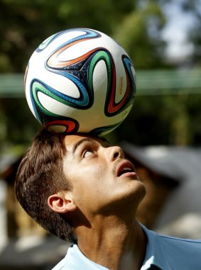 Sydney FC player Hagi Glilor tries out the Brazuca, the official 2014 World Cup soccer ball. 