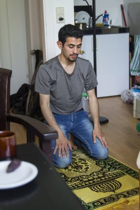 Ayham prays at his apartment in Wiesbaden. After welcoming Syrian refugees, Germany has been shocked by attacks linked to the so-called Islamic State.