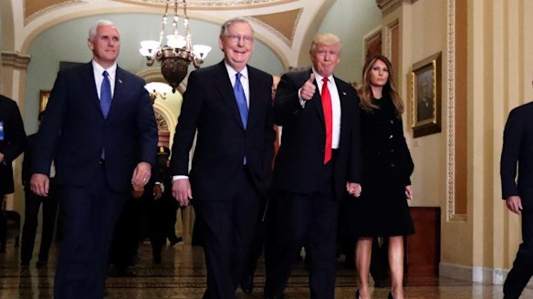 New era: Vice-President-elect Mike Pence, Senate Majority Leader Mitch McConnell, President-elect Donald Trump and his wife Melania at Capitol Hill on Friday.