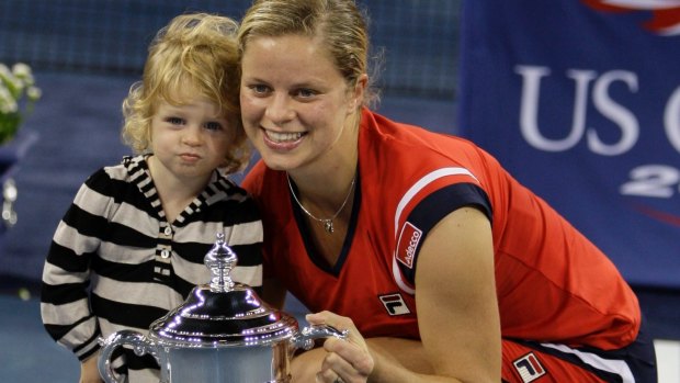 Kim Clijsters with her daughter Jada and the US Open trophy in 2009. Clijsters is one of three women who have won grand slam titles after having a baby.