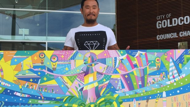 Artist Go Suga pictured with some of the artwork set to liven up the construction of Gold Coast's new cultural centre. 