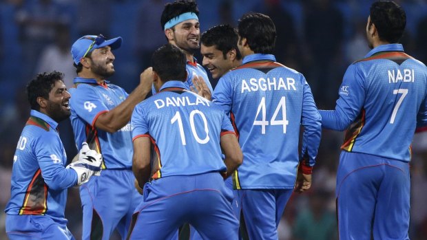 The Afghan team celebrate their upset win over West Indies in Nagpur.