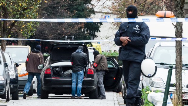 Police prepare for a raid in Brussels on November 16 amid a manhunt for a suspect of the Paris attacks.