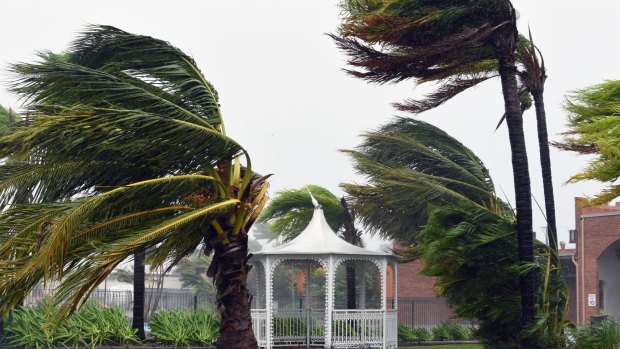 Cyclone Debbie's destructive fury batters Airlie Beach, where it damaged homes and snapped trees.