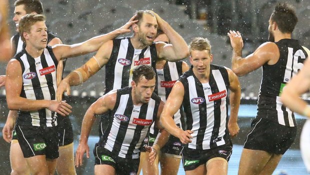 Travis Cloke and his Magpie teammates celebrate a goal in Friday night's win against Fremantle at the MCG. 