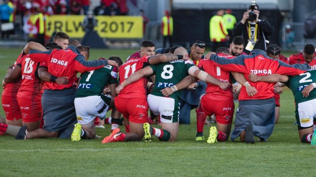 Unity: Tonga and Lebanon players share a prayer after Tonga's victory.