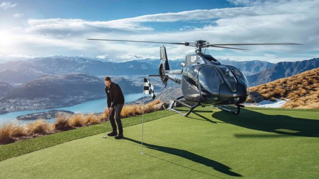 Extreme golf, anyone? A chopper conveys golfers to the green on Cecil Peak.
