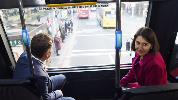 Gladys Berejiklian and Andrew Constance scope the view from the top seat of a double-decker bus