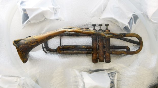 A broken trumpet from a sunken warship holds its secrets from WWII.
