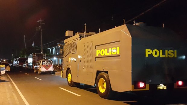 Indonesian police vehicles stand outside Bali's Kerobokan jail after the gang battle.