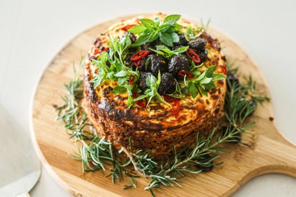 Baked spiced ricotta cake with a central layer of jammy tomatoes.