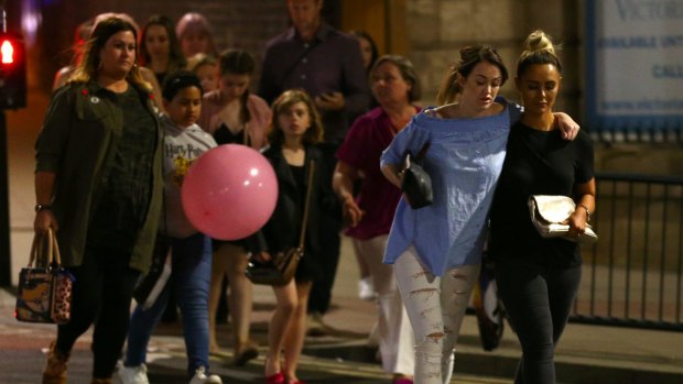 Concertgoers leave the Manchester Arena following the deadly explosion.