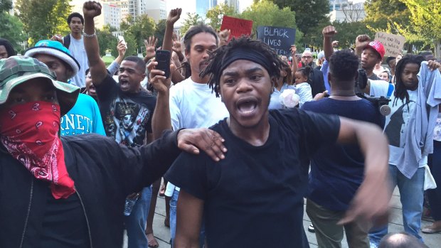 People gather in Charlotte to protest Tuesday's deadly police shooting of a black man.