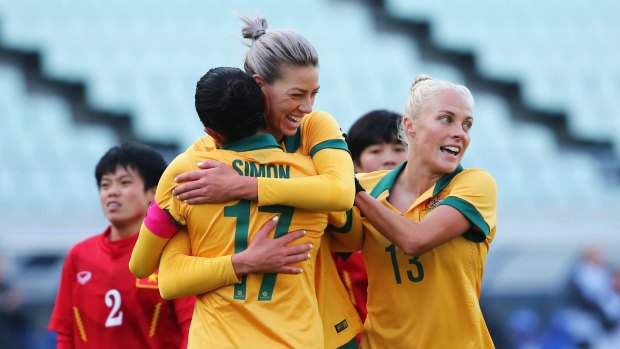 Two from two: The Matildas celebrate one of their nine goals against Vietnam.
