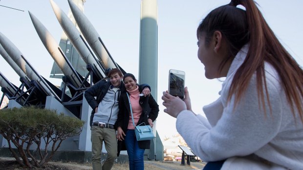Tourists pose in front of  model missiles, including a North Korean Scud-B, at the War Memorial of Korea in Seoul. North Korea's long-range rocket launch is considered by the West to form part of its efforts to develop intercontinental ballistic missile technologies.