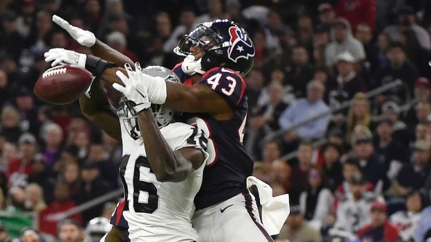 Houston's Corey Moore  breaks up a pass intended for Raiders wide receiver Johnny Holton.