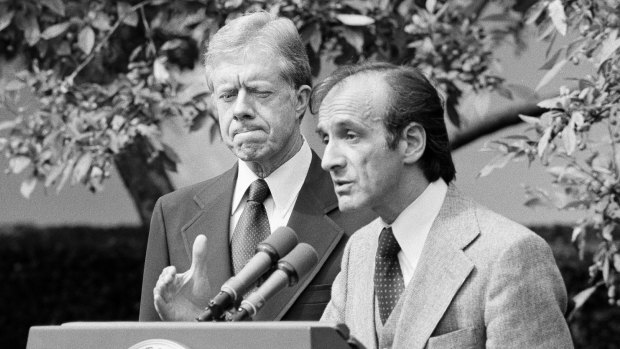 President Jimmy Carter standing by as Elie Wiesel, chairman of the president's Holocaust committee speaks in the White House Rose Garden in 1979.