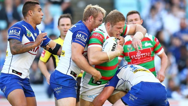 Hot tempered: George Burgess is wrapped up at ANZ Stadium.