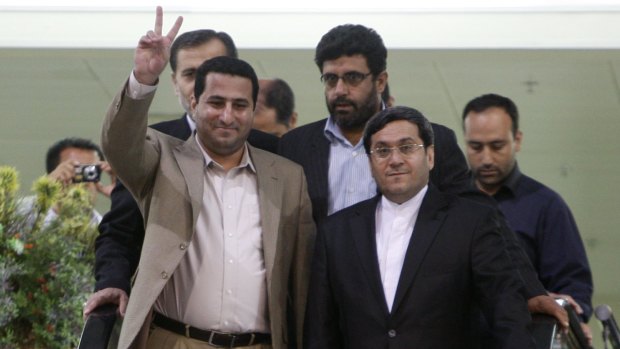 Shahram Amiri (left) returns to Iran in July 2010, and is met by Iran's Deputy Foreign Minister Hassan Qashqavi. 