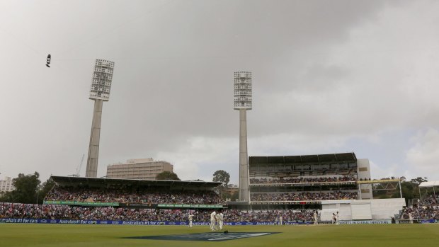 Rain pain: Storm clouds gather over the WACA ground shortly before rain stopped play on Sunday.