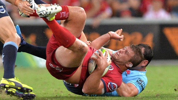 James Slipper of the Reds is tackled during the round-four Super Rugby match against the NSW Waratahs on Saturday night.