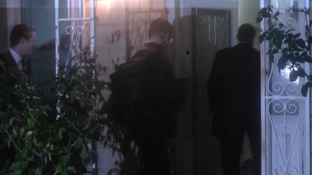 AFP agents raid a Labor staffer's house in Melbourne.