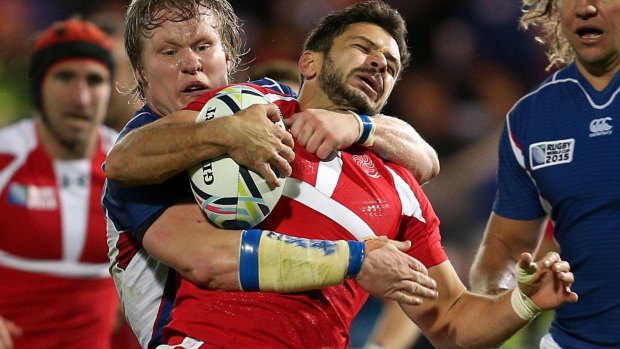 In the bin: Georgia's Lasha Malaguradze is tackled by Namibia's Renaldo Bothma - who received a yellow card for his efforts.