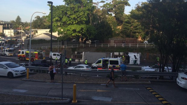 A truck lies on its side on Warringah Road in Dee Why following an accident.