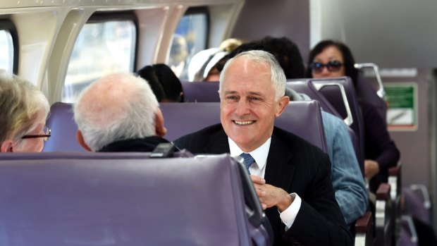 Prime Minister, Malcolm Turnbull, pictured here on a train in Sydney's west, has announced a "City Deal" for the region.