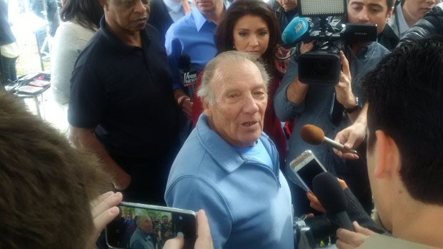 Frenzy ... Landlord Doyle Miller stands in the middle of a media scrum after opening up his apartment to reporters.