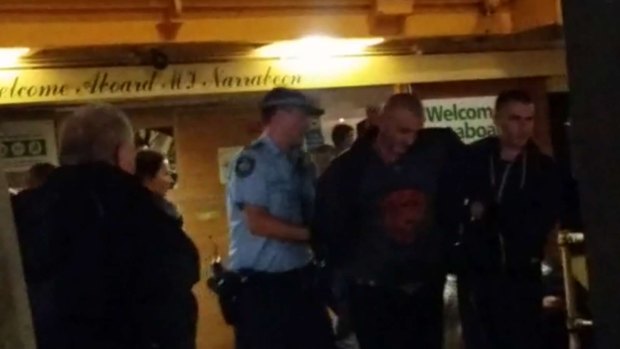 Police take a man off the ferry on Wednesday night.