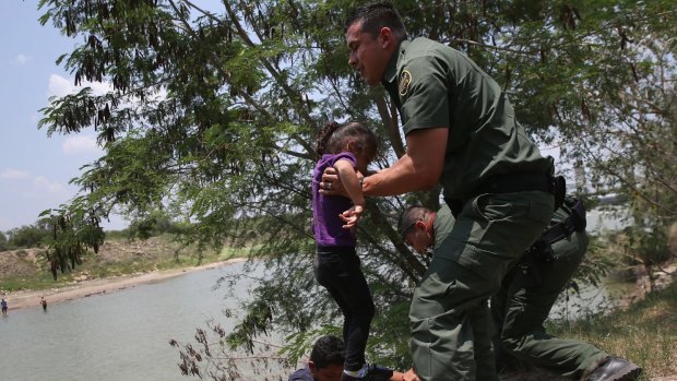 The US-Mexican border is porous and even attracts migrants from beyond Latin America. US Border Patrol agents help minors from El Salvador after they crossed the Rio Grande illegally into the United States.