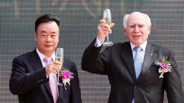 Chau Chak Wing and John Howard share a toast in 2011. 