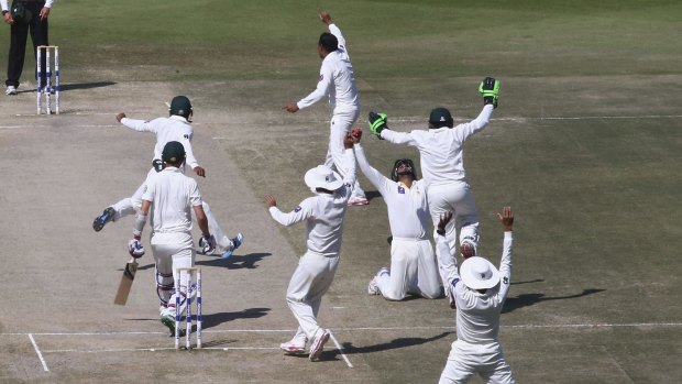Over and out: Pakistan players celebrate after defeating Australia in the second Test.