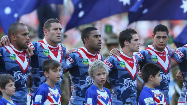 NRL tradition: Sydney Roosters players line up before the national anthem on Anzac Day in 2013.