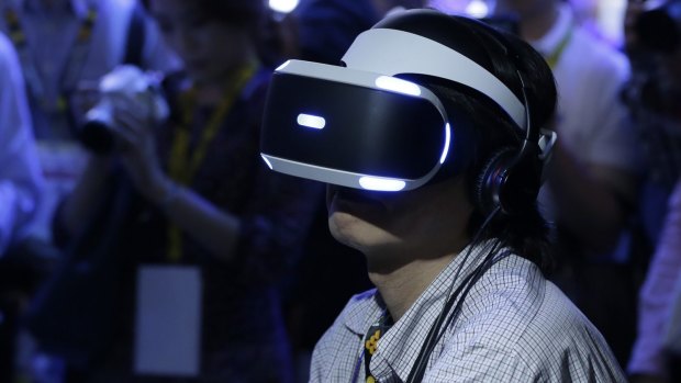 A Tokyo Game Show attendee tries out the PlayStation VR headset.