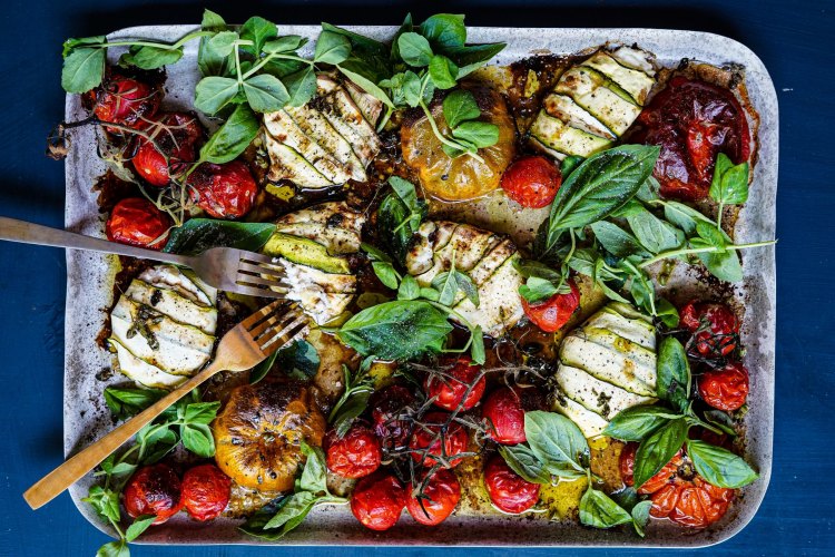 Zucchini wrapped cheese with tomatoes and fresh herbs. Summer traybake recipes and sheetpan dinners for Good Food, January 2020. Images and recipes by KatrinaÂ Meynink. Good Food use only. One tray wonders.